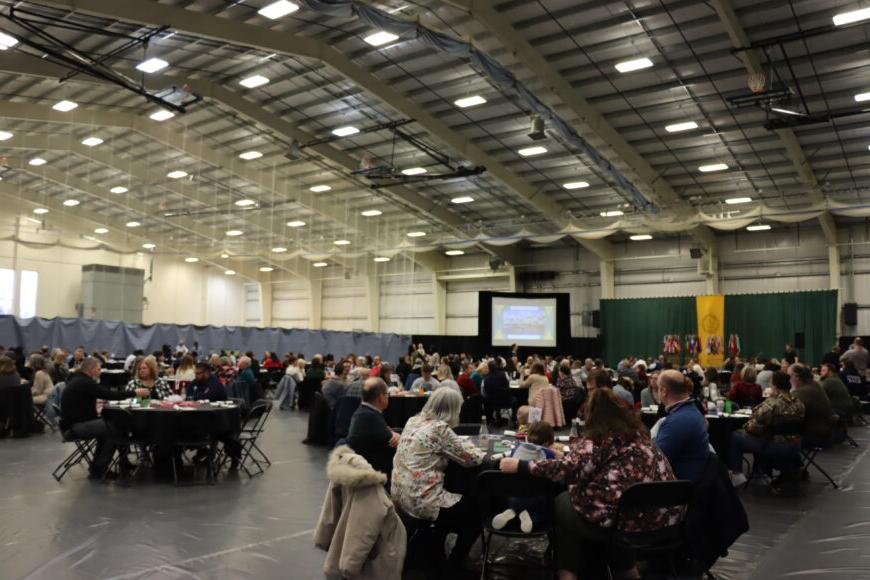 Wide shot of the international dinner with many people and tables