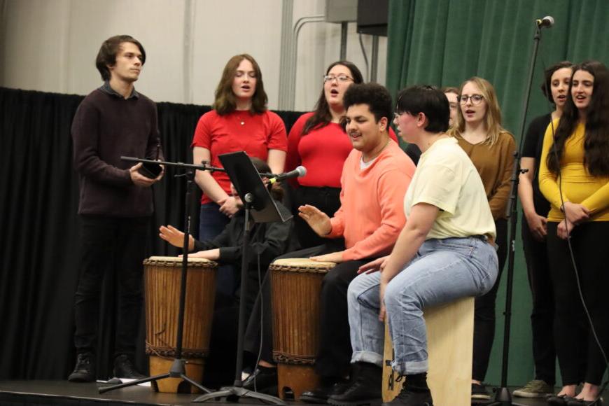 TU students performing with drums on a stage